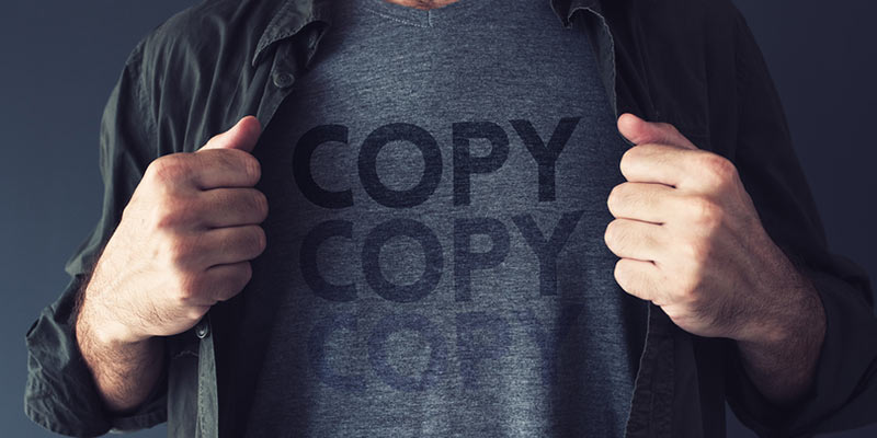 Man in a T-shirt with word COPY written on it three times