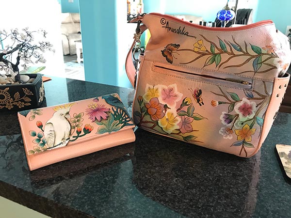 Pink purse with flowers on it.