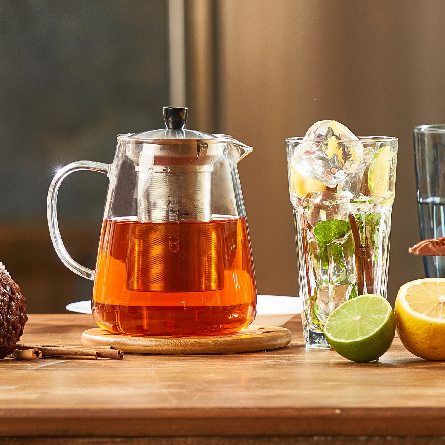 Picture of a glass teapot with tea backlit by the sun.
