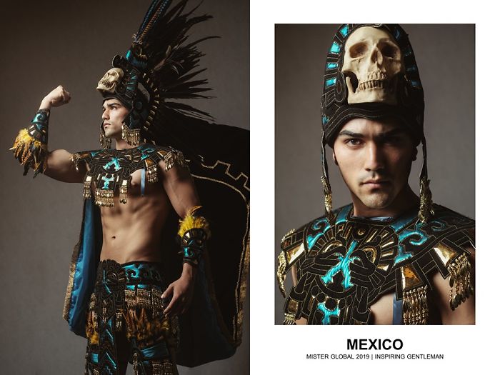 Man in a Mexican national costumes: Aztec embroidery, turquoise, gold, and black, feathered headdress.