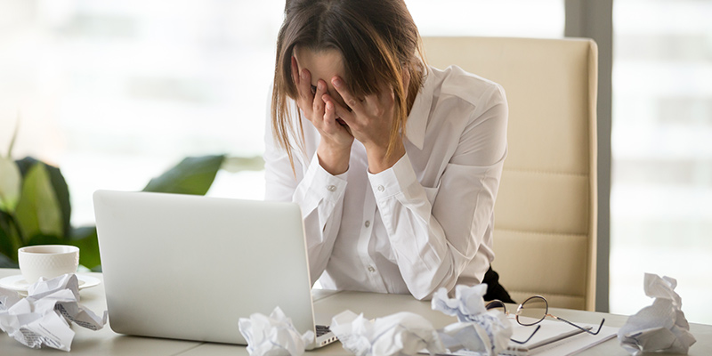 Stressed out writer crying at her laptop