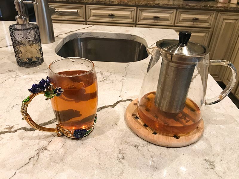 Picture of a tea pot and some tea in a pretty mug