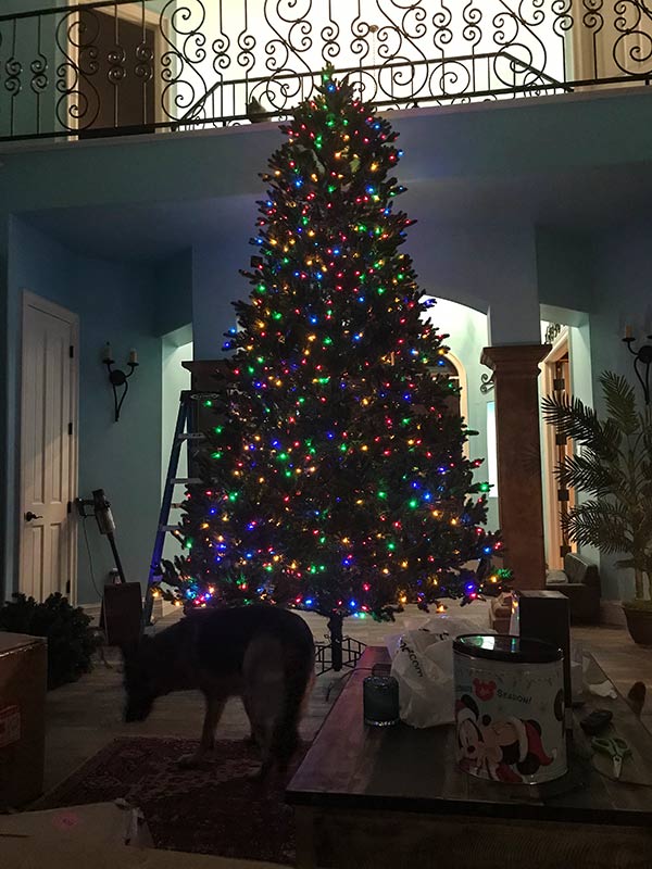 Artificial tree with a large German Shepherd for scale.