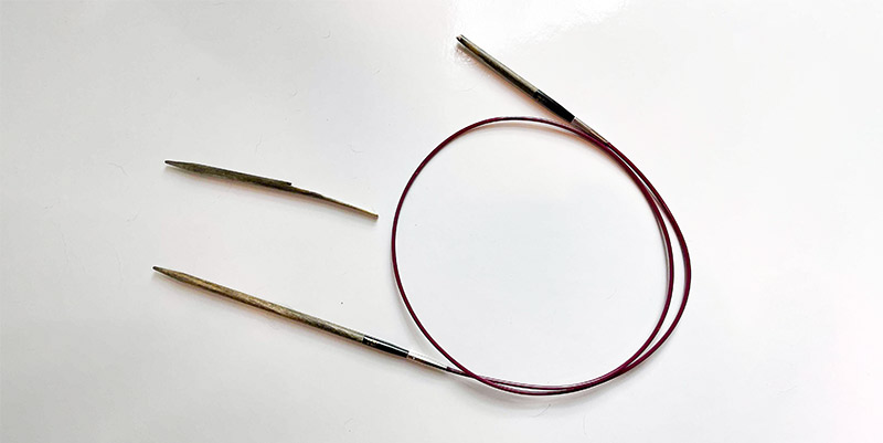 Picture of a broken circular knitting needle.
