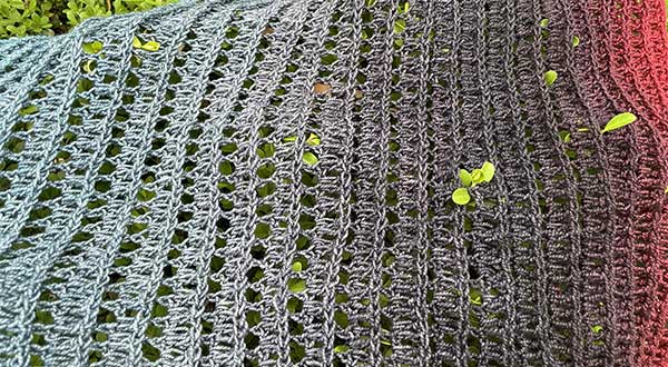 Close up of the color transitions in the shawl: blue to grey to black to brown to burgundy