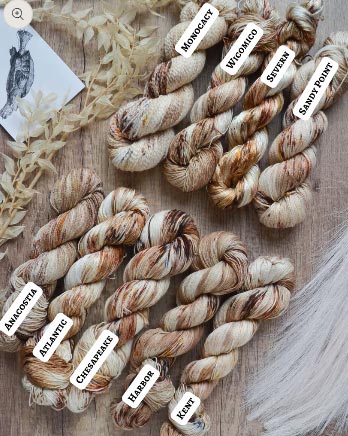 Picture of the same yarn dye pattern as above on a variety of skeins.