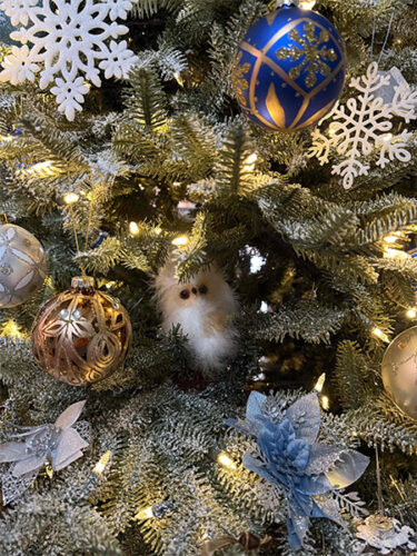 Images of Christmas tree with blue, silver and gold ornaments and a cute little fuzzy white owl