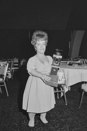 Beautiful portrait of Judy-Lynn Del Rey in a light dress holding an award