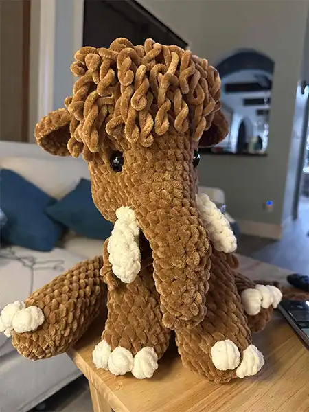 A different angle of a stuffed crochet mammoth made of chenille yarn, kind of cute. 